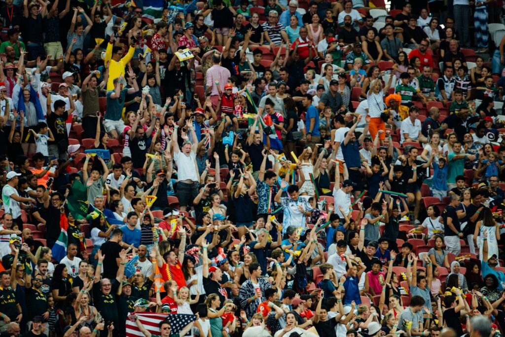 Crowd of people cheering in a packed stadium
